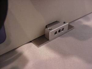 Figure 10 Tightening the base plate clamp to secure the base plate to the microscope Figure 10 Tightening the base plate clamp to secure the base plate to the microscope